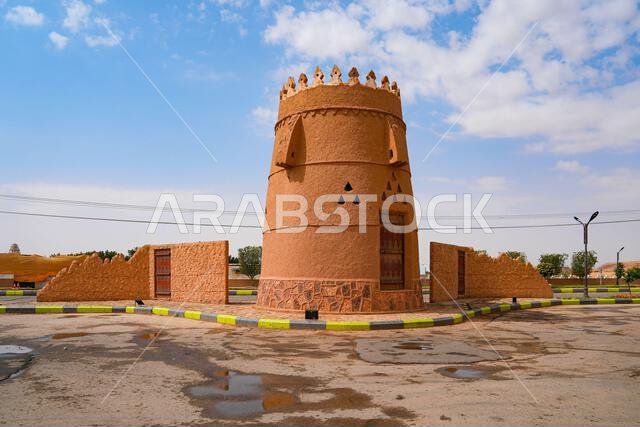A traditional mud brick watchtower and defensive wall in the heritage village of Ushaiqer, Saudi Arabia