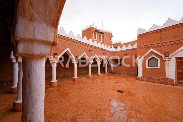 Arcade in the courtyard of Al-Faylaqia Mosque with white crenellations in Ushaiqer, Saudi Arabia