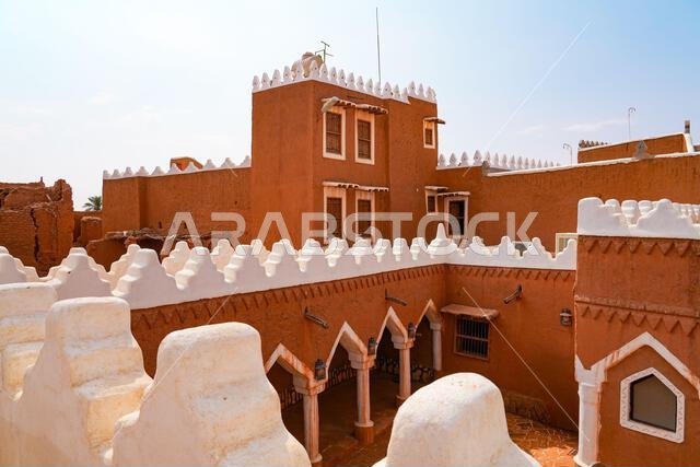 Pillars and courtyard of Al-Faylaqia Mosque with white crenellations in Ushaiqer, Saudi Arabia