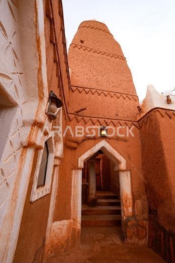 Low angle view of the mud brick minaret of Al-Faylaqia Mosque in Ushaiqer, Saudi Arabia