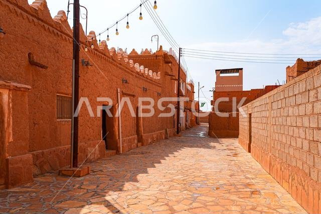 Paved street flanked with mud brick houses in the heritage village of Ushaiqer, Saudi Arabia