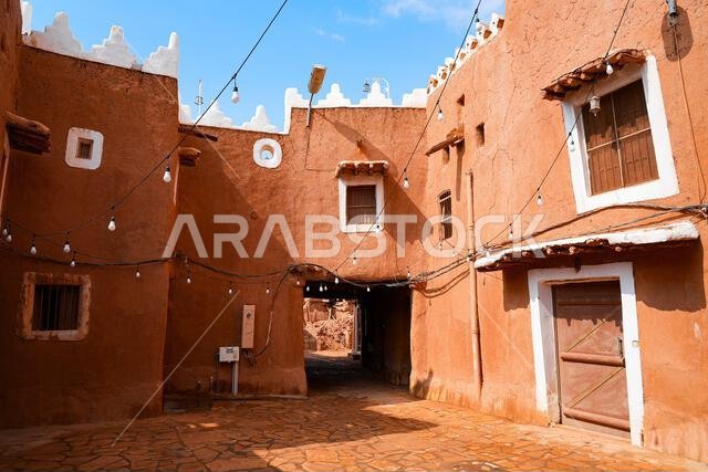 Paved street flanked with mud brick houses in the heritage village of Ushaiqer, Saudi Arabia
