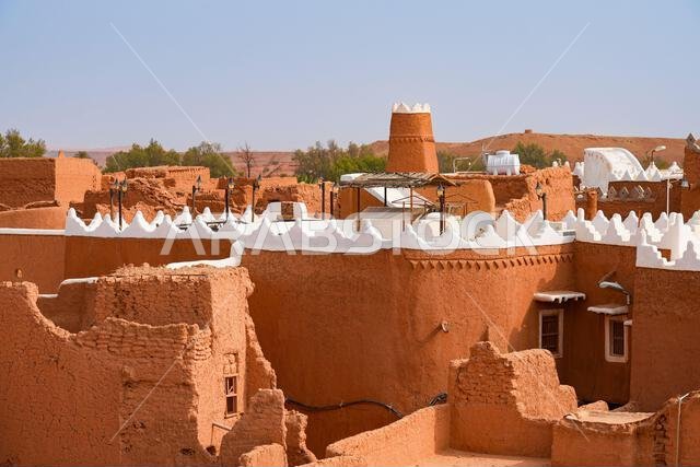Aerial view of the traditional mud brick Al-Faylaqia Mosque with white crenellations in Ushaiqer, Saudi Arabia