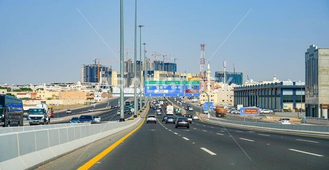 Modern highway infrastructure and traffic signs directing to Masjid Quba in Madinah, Saudi Arabia