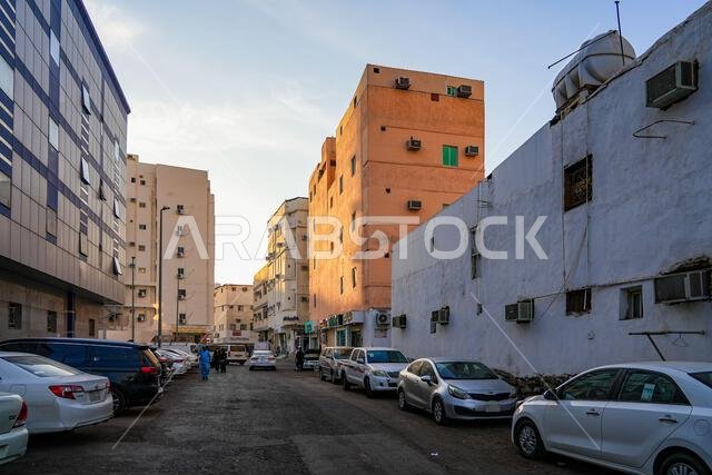 Cars parked along a residential side street with colorful apartment buildings in Madinah, Saudi Arabia Cars parked along a residential side street with colorful apartment buildings in Madinah, Saudi Arabia