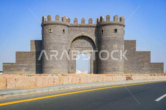 The monumental Bab Al Madinah Al Munawwarah basalt stone gate by the roadside in Madinah, Saudi Arabia