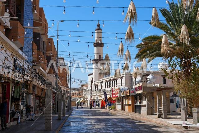 Pedestrian street decorated with hanging ornaments leading to a mosque in Al Balad historic area of Taif in Saudi Arabia