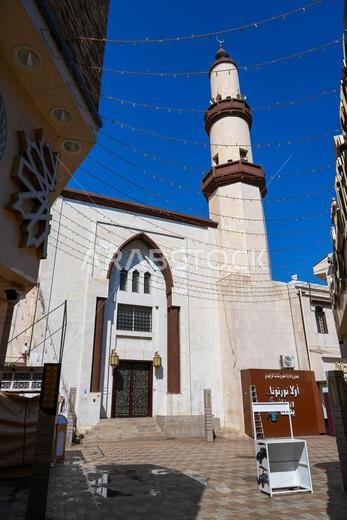 Front facade and minaret of a traditional mosque in Al Balad historic district of Taif in Saudi Arabia
