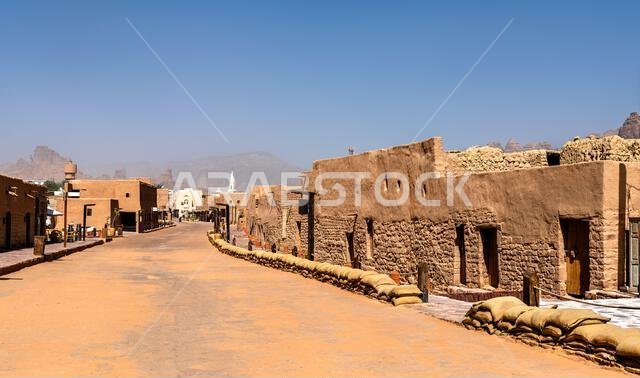 View of the historic mud brick architecture and narrow streets in the Old Town of AlUla, Saudi Arabia, featuring traditional desert construction and mountain backdrops. View of the historic mud brick architecture and narrow streets in the Old Town of AlUla, Saudi Arabia, featuring traditional desert construction and mountain backdrops.