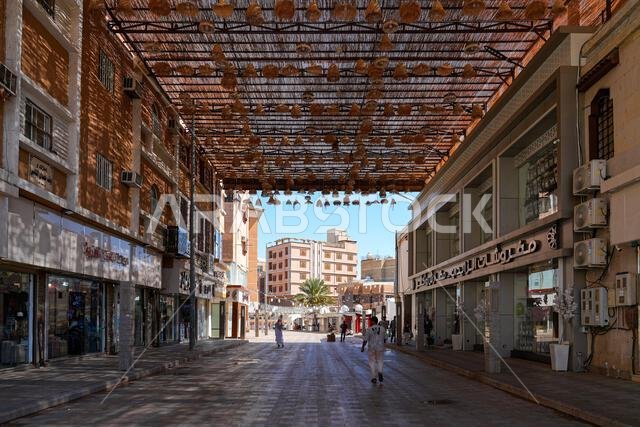Wide pedestrian shopping street with a large overhead shade structure in Al Balad of Taif, Saudi Arabia Wide pedestrian shopping street with a large overhead shade structure in Al Balad of Taif, Saudi Arabia