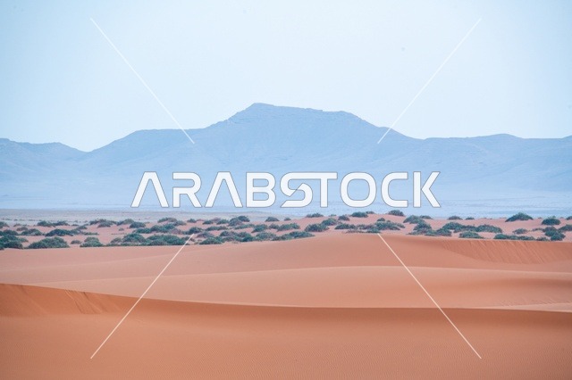 الكثبان الرملية الحمراء والجبال في صحراء النفود
