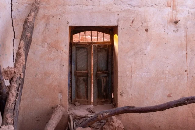 Traditional Arabic Mud House Wooden Door with Sunlight