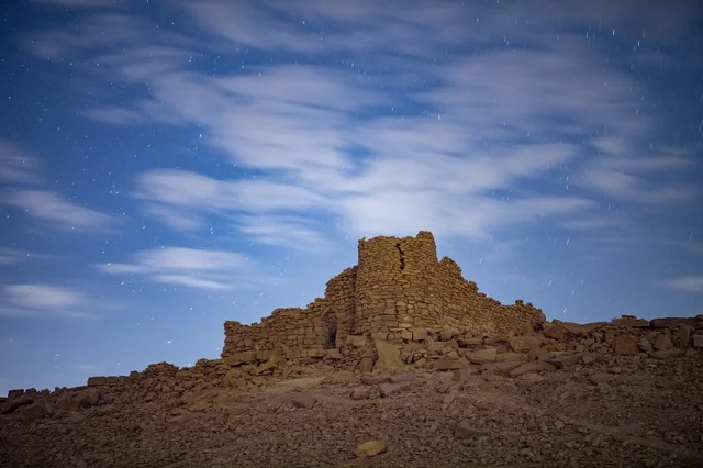 Ancient Stone Fortress Ruins Under Night Starry Sky