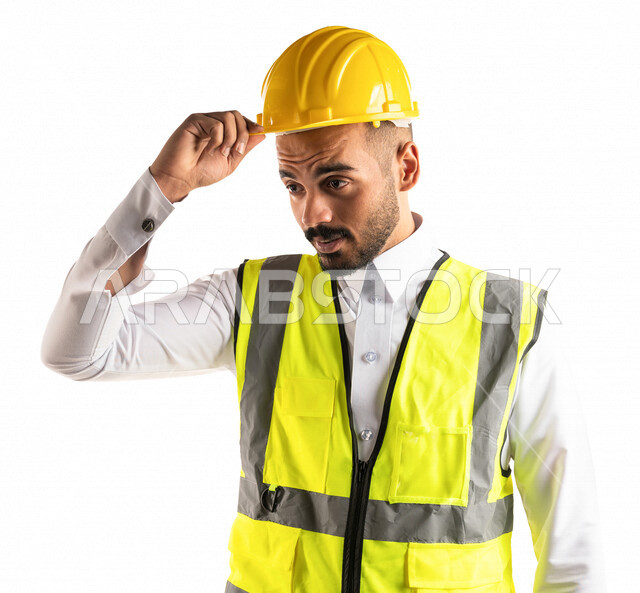 Portrait of a Saudi Arabian Gulf engineer wearing a work helmet and safety vest, holding a safety helmet with his hand, engineering professions and jobs, architecture concept, professional architect, white background