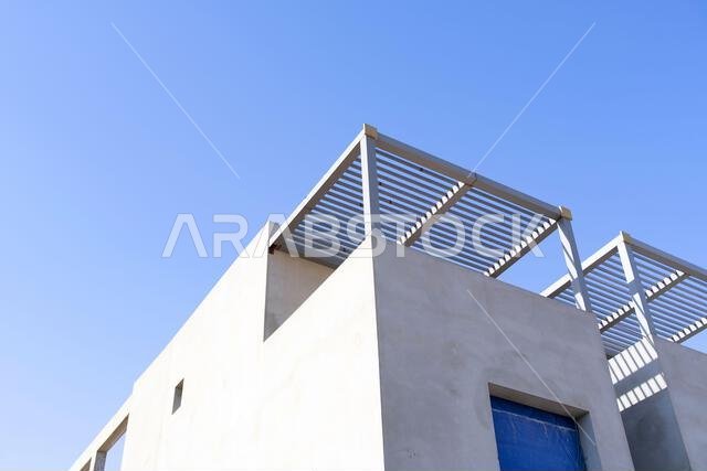 New house under construction in Riyadh, Saudi Arabia, showing cement walls, unfinished structure, and early building stages of a residential property.