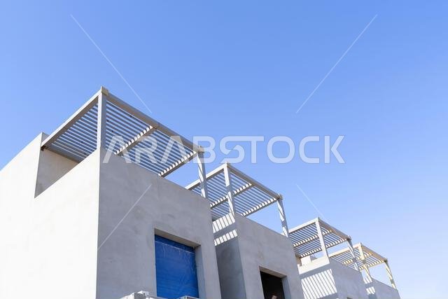 New house under construction in Riyadh, Saudi Arabia, showing cement walls, unfinished structure, and early building stages of a residential property.