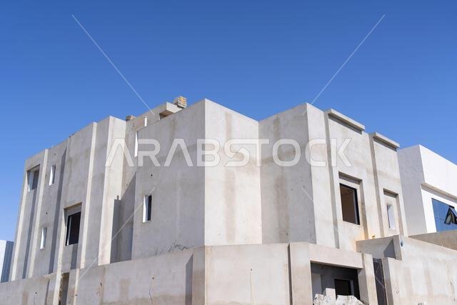 New house under construction in Riyadh, Saudi Arabia, showing cement walls, unfinished structure, and early building stages of a residential property. New house under construction in Riyadh, Saudi Arabia, showing cement walls, unfinished structure, and early building stages of a residential property.