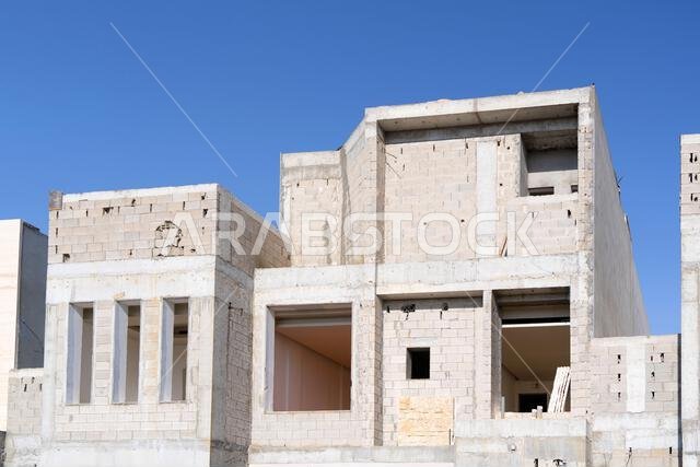 New house under construction in Riyadh, Saudi Arabia, showing cement walls, unfinished structure, and early building stages of a residential property. New house under construction in Riyadh, Saudi Arabia, showing cement walls, unfinished structure, and early building stages of a residential property.