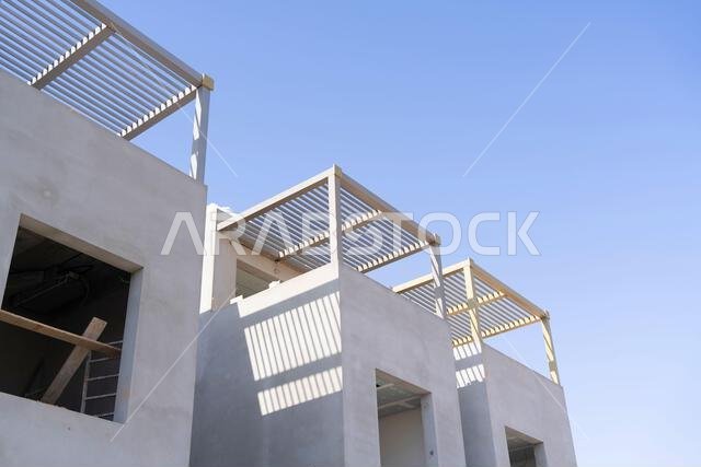 New house under construction in Riyadh, Saudi Arabia, showing cement walls, unfinished structure, and early building stages of a residential property.