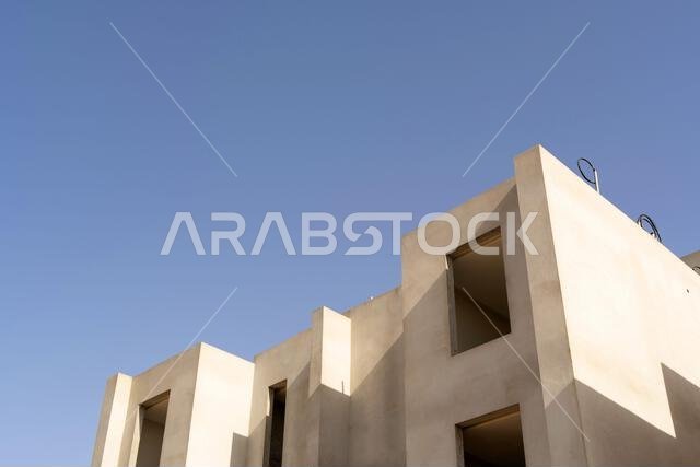New house under construction in Riyadh, Saudi Arabia, showing cement walls, unfinished structure, and early building stages of a residential property.