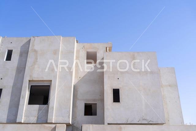 New house under construction in Riyadh, Saudi Arabia, showing cement walls, unfinished structure, and early building stages of a residential property.