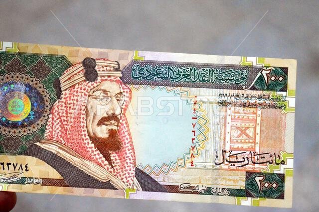 The obverse side of 200 SAR two hundred Saudi Arabia riyal cash money banknote bill, features King Abdulaziz Al Saud, picture of the door of Al-Masmak