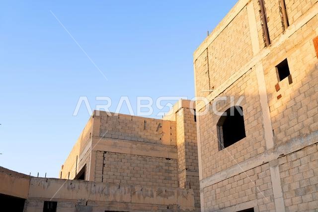 New house under construction in Riyadh, Saudi Arabia, showing cement walls, unfinished structure, and early building stages of a residential property. New house under construction in Riyadh, Saudi Arabia, showing cement walls, unfinished structure, and early building stages of a residential property.
