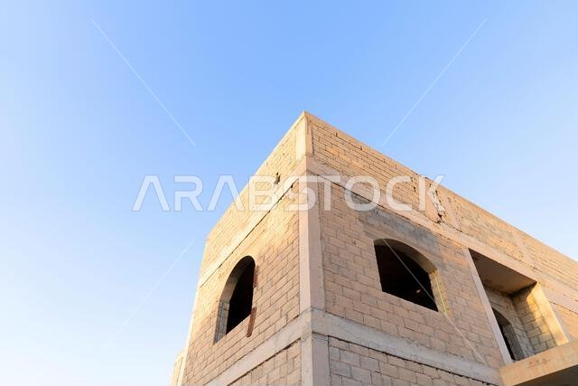 New house under construction in Riyadh, Saudi Arabia, showing cement walls, unfinished structure, and early building stages of a residential property. New house under construction in Riyadh, Saudi Arabia, showing cement walls, unfinished structure, and early building stages of a residential property.