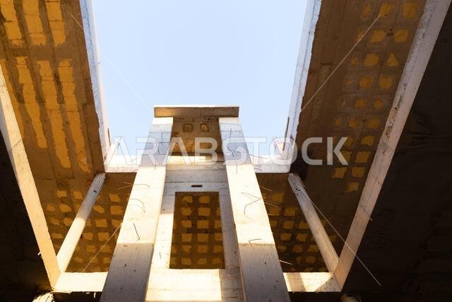 New house under construction in Riyadh, Saudi Arabia, showing cement walls, unfinished structure, and early building stages of a residential property.