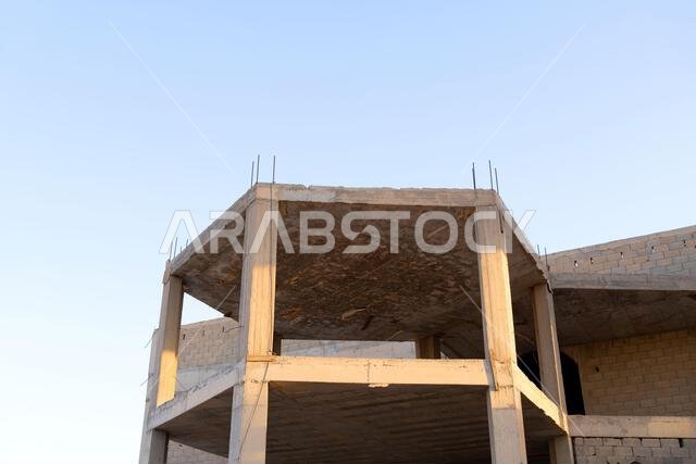 New house under construction in Riyadh, Saudi Arabia, showing cement walls, unfinished structure, and early building stages of a residential property.