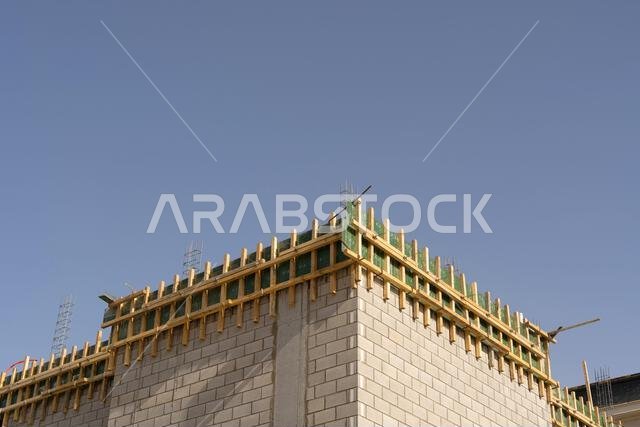 New house under construction in Riyadh, Saudi Arabia, showing cement walls, unfinished structure, and early building stages of a residential property. New house under construction in Riyadh, Saudi Arabia, showing cement walls, unfinished structure, and early building stages of a residential property.