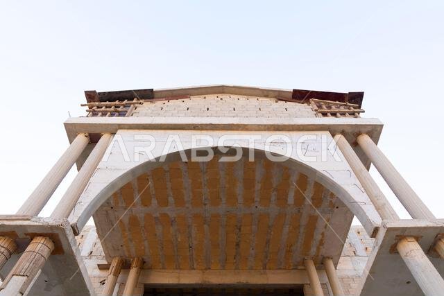 New house under construction in Riyadh, Saudi Arabia, showing cement walls, unfinished structure, and early building stages of a residential property.