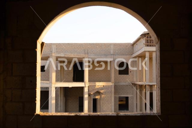 New house under construction in Riyadh, Saudi Arabia, showing cement walls, unfinished structure, and early building stages of a residential property.