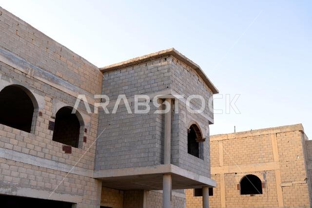 New house under construction in Riyadh, Saudi Arabia, showing cement walls, unfinished structure, and early building stages of a residential property. New house under construction in Riyadh, Saudi Arabia, showing cement walls, unfinished structure, and early building stages of a residential property.