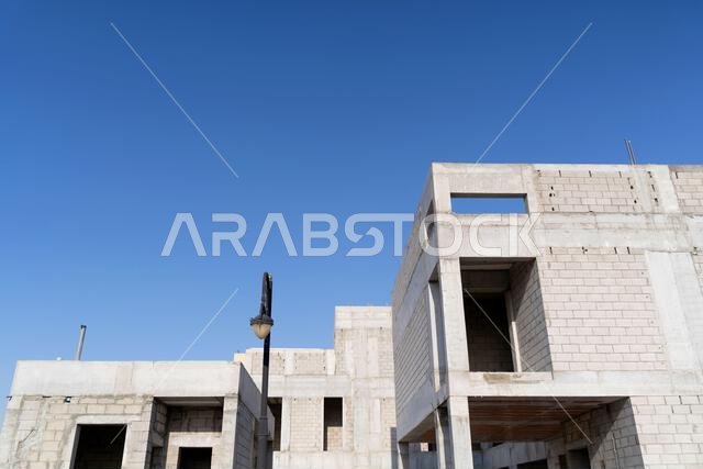 New house under construction in Riyadh, Saudi Arabia, showing cement walls, unfinished structure, and early building stages of a residential property.