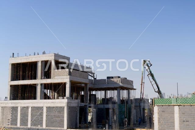 New house under construction in Riyadh, Saudi Arabia, showing cement walls, unfinished structure, and early building stages of a residential property. New house under construction in Riyadh, Saudi Arabia, showing cement walls, unfinished structure, and early building stages of a residential property.