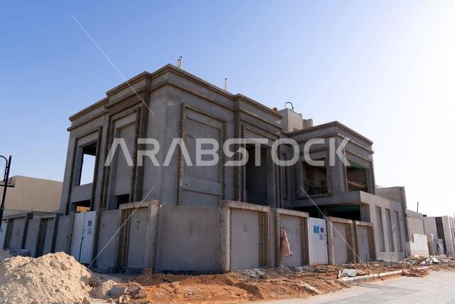 New house under construction in Riyadh, Saudi Arabia, showing cement walls, unfinished structure, and early building stages of a residential property.