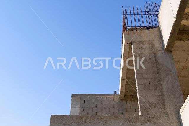 New house under construction in Riyadh, Saudi Arabia, showing cement walls, unfinished structure, and early building stages of a residential property.