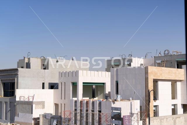 New house under construction in Riyadh, Saudi Arabia, showing cement walls, unfinished structure, and early building stages of a residential property.