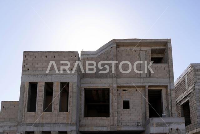 New house under construction in Riyadh, Saudi Arabia, showing cement walls, unfinished structure, and early building stages of a residential property. New house under construction in Riyadh, Saudi Arabia, showing cement walls, unfinished structure, and early building stages of a residential property.