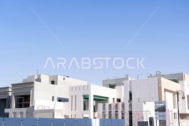 New house under construction in Riyadh, Saudi Arabia, showing cement walls, unfinished structure, and early building stages of a residential property.