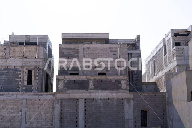 New house under construction in Riyadh, Saudi Arabia, showing cement walls, unfinished structure, and early building stages of a residential property.