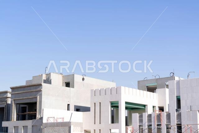 New house under construction in Riyadh, Saudi Arabia, showing cement walls, unfinished structure, and early building stages of a residential property.
