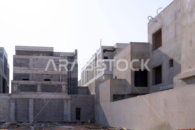 New house under construction in Riyadh, Saudi Arabia, showing cement walls, unfinished structure, and early building stages of a residential property.