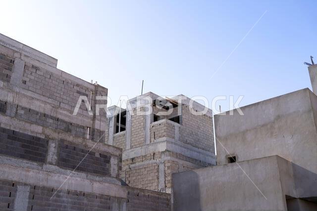 New house under construction in Riyadh, Saudi Arabia, showing cement walls, unfinished structure, and early building stages of a residential property.