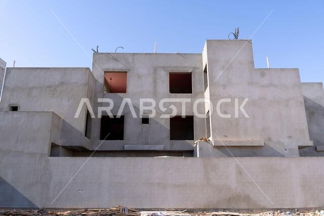 New house under construction in Riyadh, Saudi Arabia, showing cement walls, unfinished structure, and early building stages of a residential property.