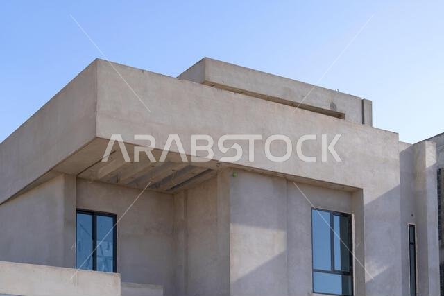 New house under construction in Riyadh, Saudi Arabia, showing cement walls, unfinished structure, and early building stages of a residential property.