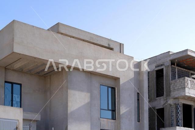 New house under construction in Riyadh, Saudi Arabia, showing cement walls, unfinished structure, and early building stages of a residential property.