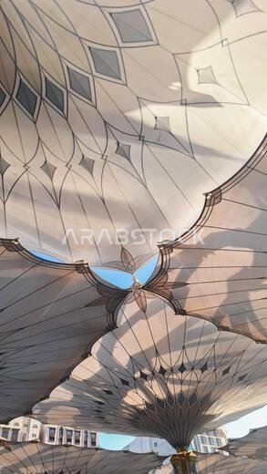 Medina, Saudi Arabia - March 7, 2024: Exterior architecture of giant umbrella at the Masjid an-Nabawi Medina, Saudi Arabia - March 7, 2024: Exterior architecture of giant umbrella at the Masjid an-Nabawi