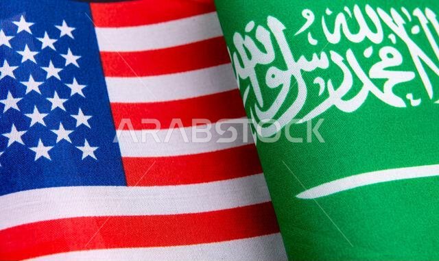 A close up of the USA national flag together with the Saudi Arabia national flag. A USA, Saudi Arabia relations concept.